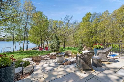 Just outside the Kitchen, the paver patio features a plumbed gas line to the grill and a motorized retractable sun shade.