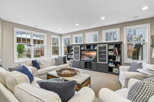 The lower level Family Room features a built-in entertainment center and looks out to the pool.