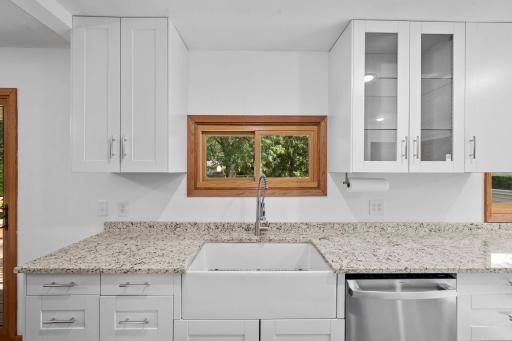The Kitchen boasts a farmhouse style sink!