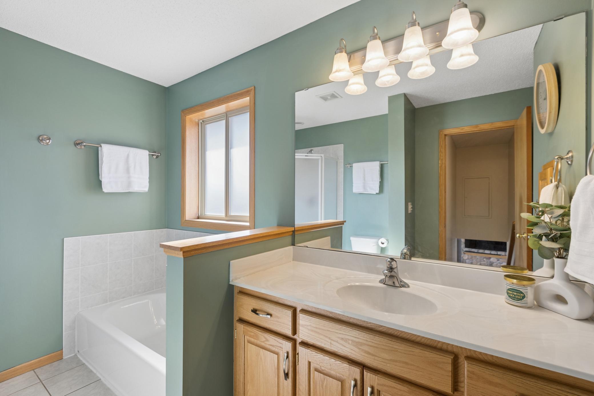 Upper level full bath features separate tub, stand alone shower, and great counter space