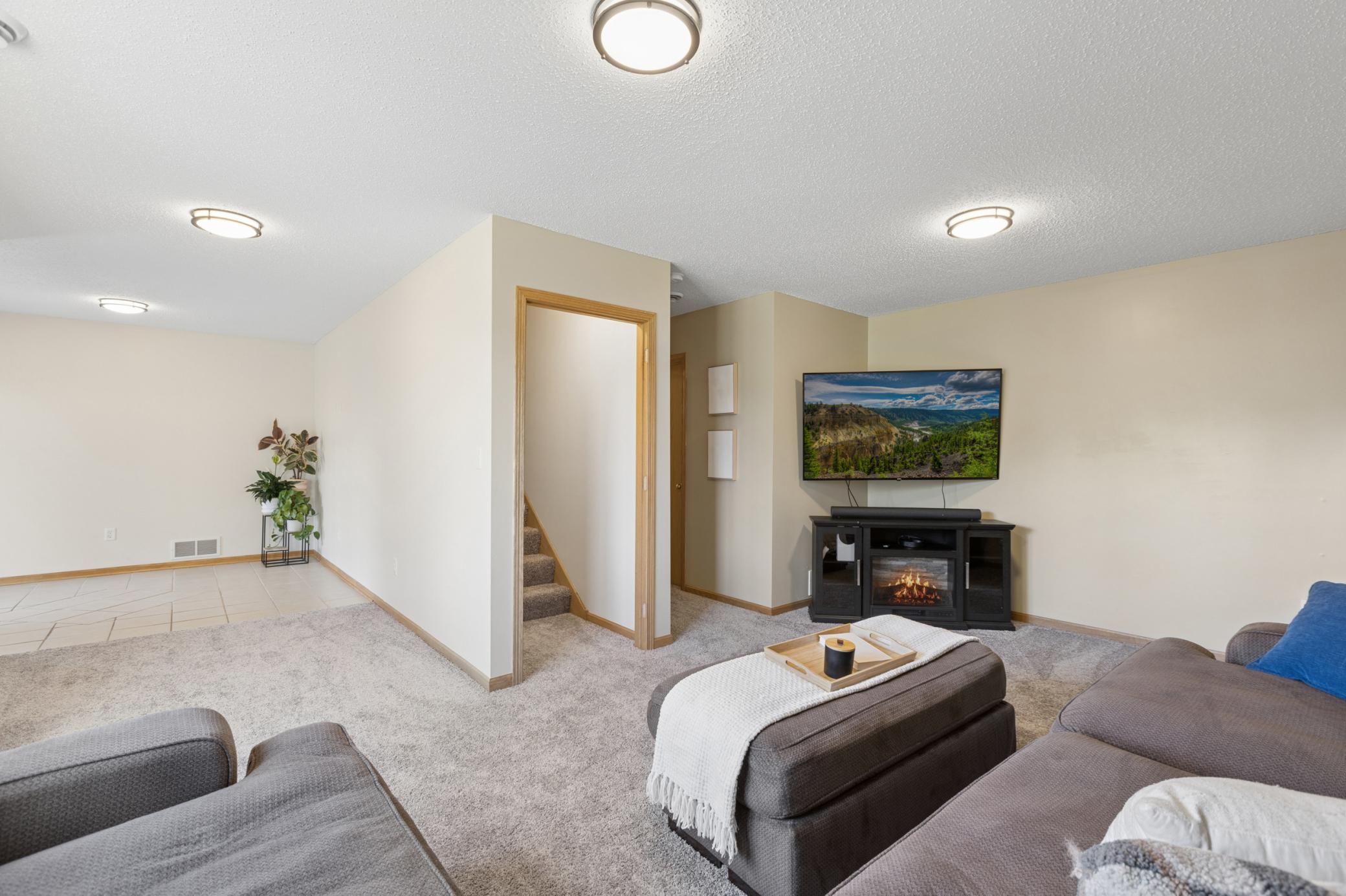 Lower level family room offers large windows with LIGHT and plush carpet!