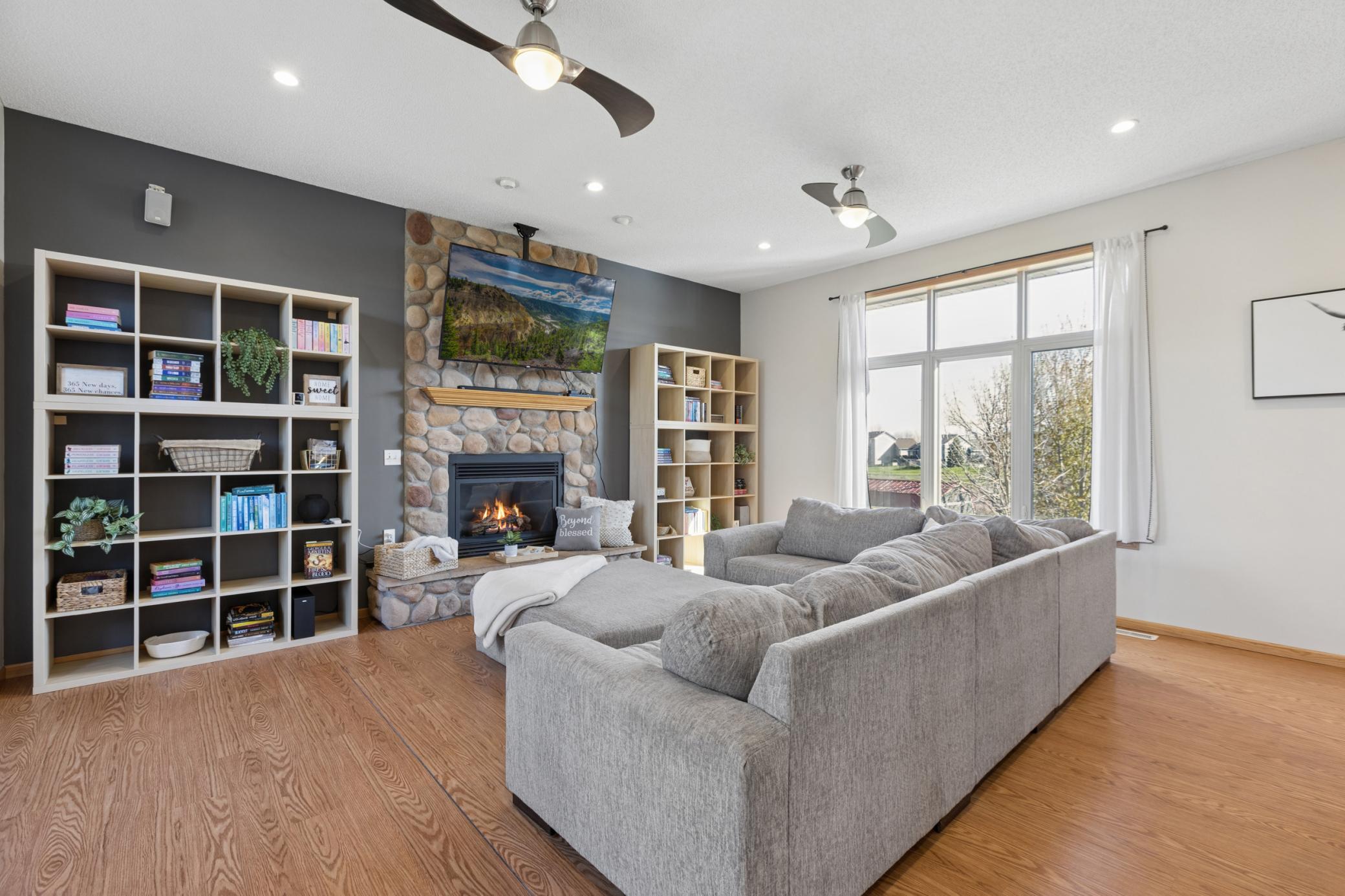 Inviting main floor living room w/ extra tall ceiling, recessed lighting, and wonderful transom windows for excellent backyard views and loads of soothing natural light!!