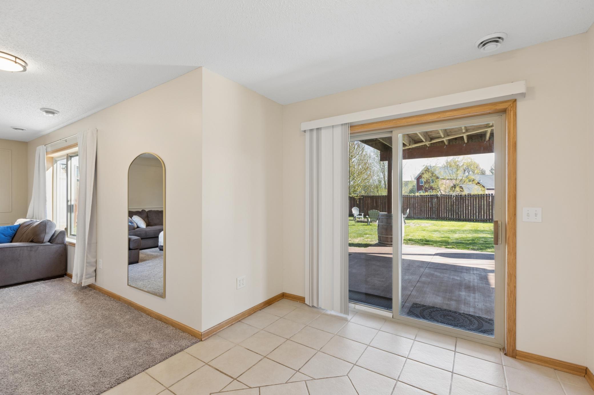 Lower level "flex" space is perfect as a reading nook or adding a table for game night! The door opens up to the backyard and patio area