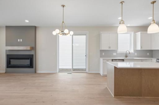 Dining walks out to patio and private side yard with fence.