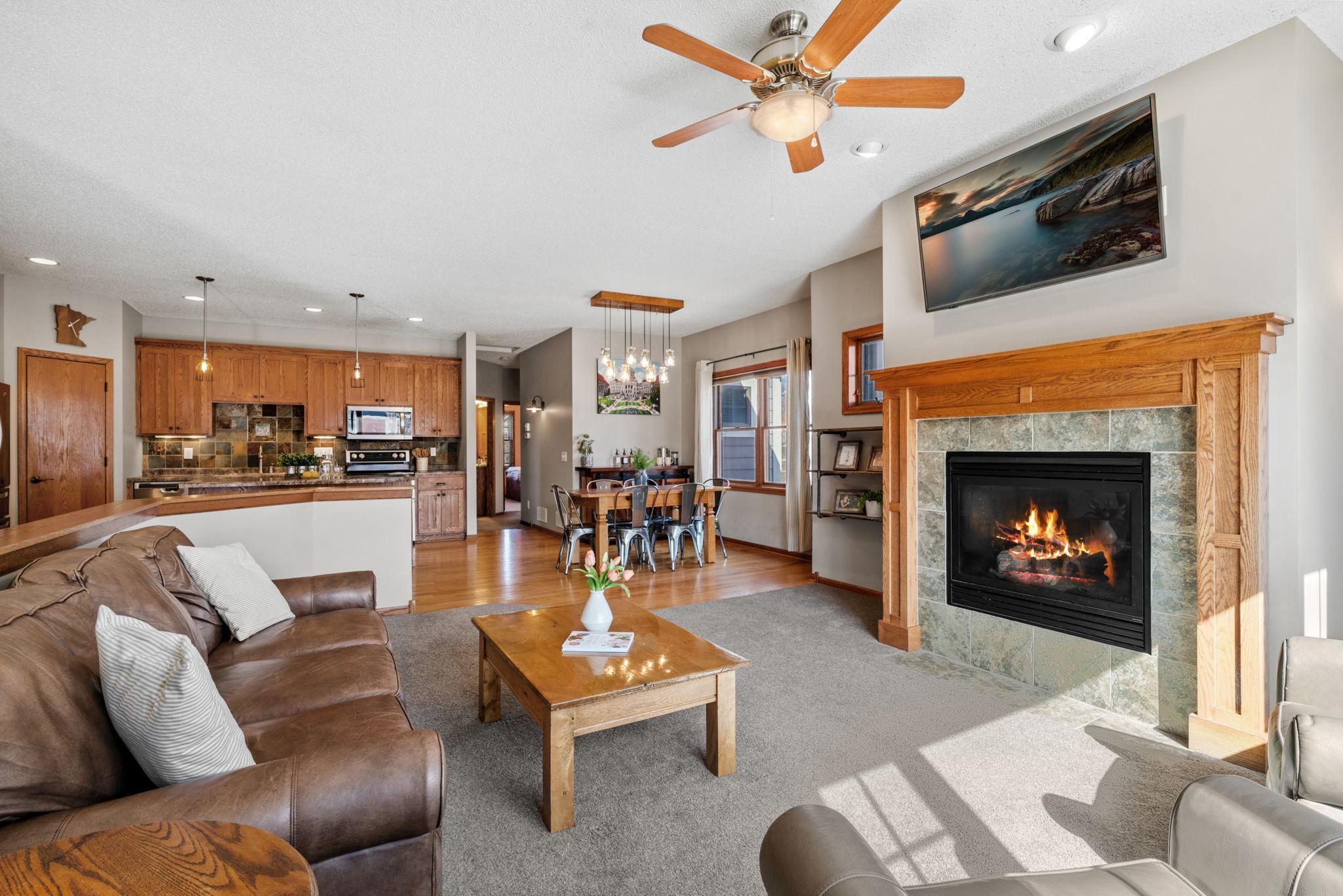 Open concept living room with cozy fireplace and great natural light.
