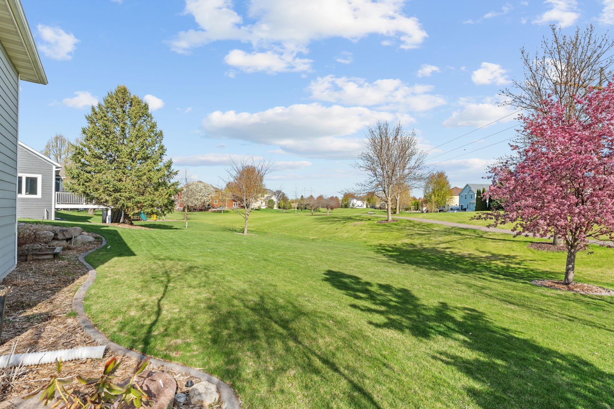 Backyard views and open green space create a peaceful outdoor setting.