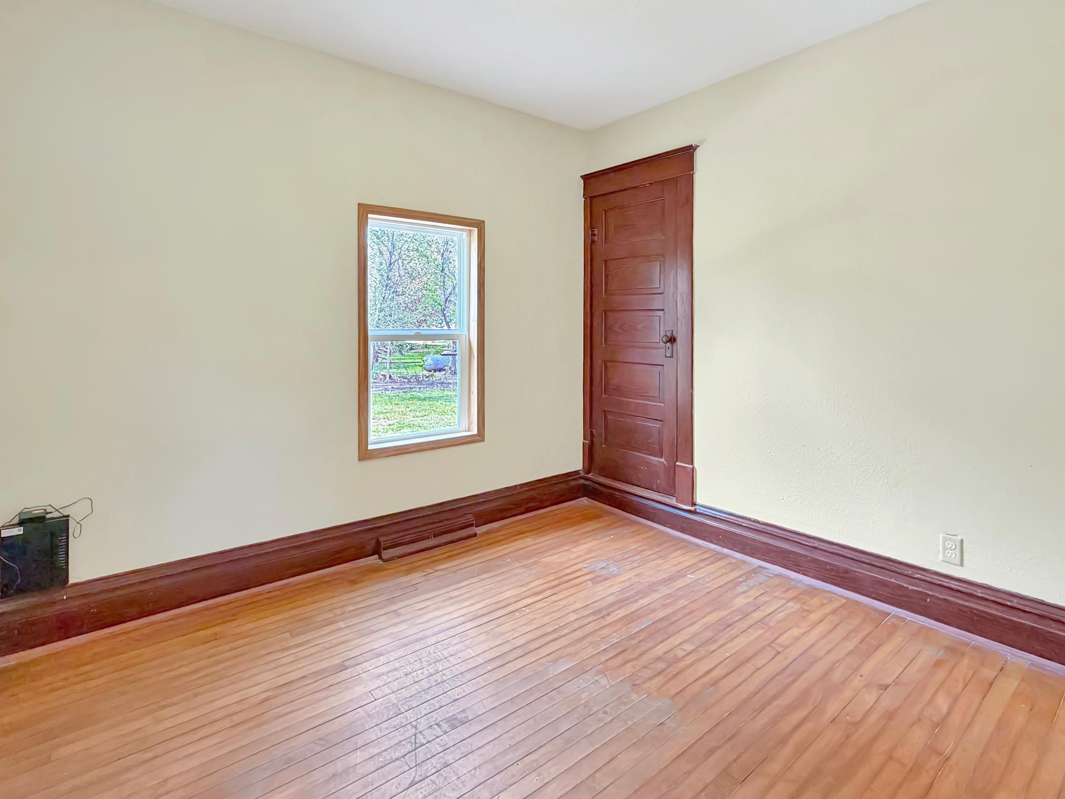 Second main floor bedroom with real hardwood flooring