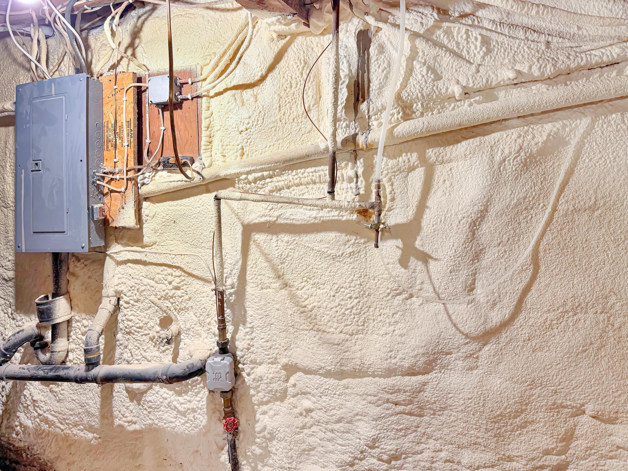 Electrical panel and spray foamed wall, to help insulate