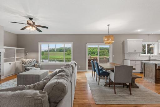 Living room & dining room with huge windows showing gorgeous views of kitchen