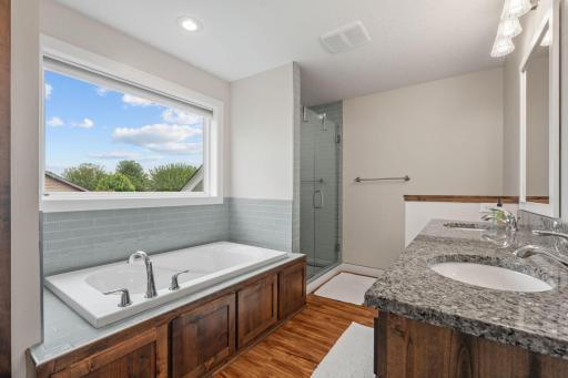 Primary Ensuite Bath - Jacuzzi tub, walk in shower, double vanity, tucked away toilet and large walk in closet on right