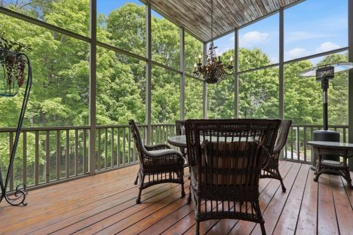 Off the living room is one of three gorgeous, screened porches.