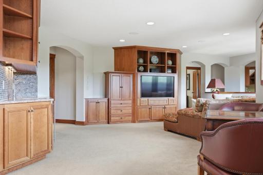 The upstairs offers a cozy living space, complete with wet bar and custom built-ins.