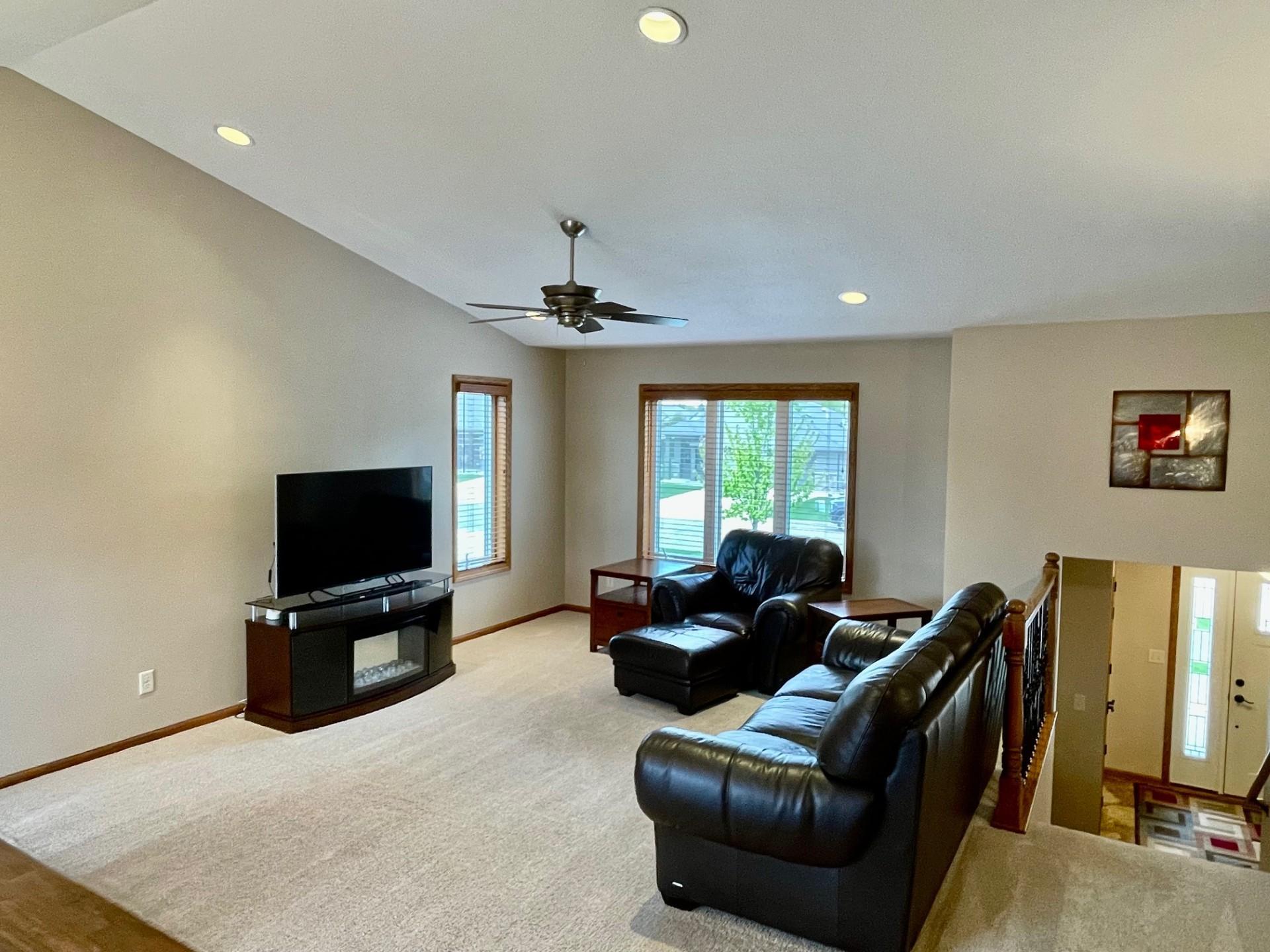 Living room with vaulted ceiling, recessed lighting