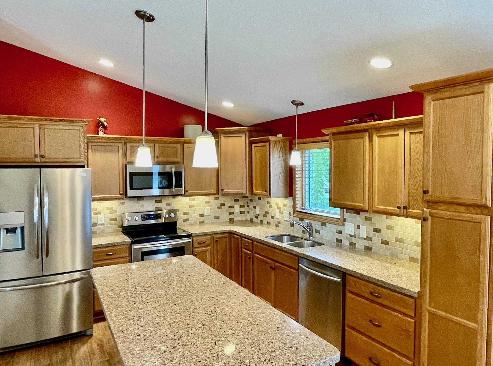 Stainless steel appliances, pendant and recessed lighting