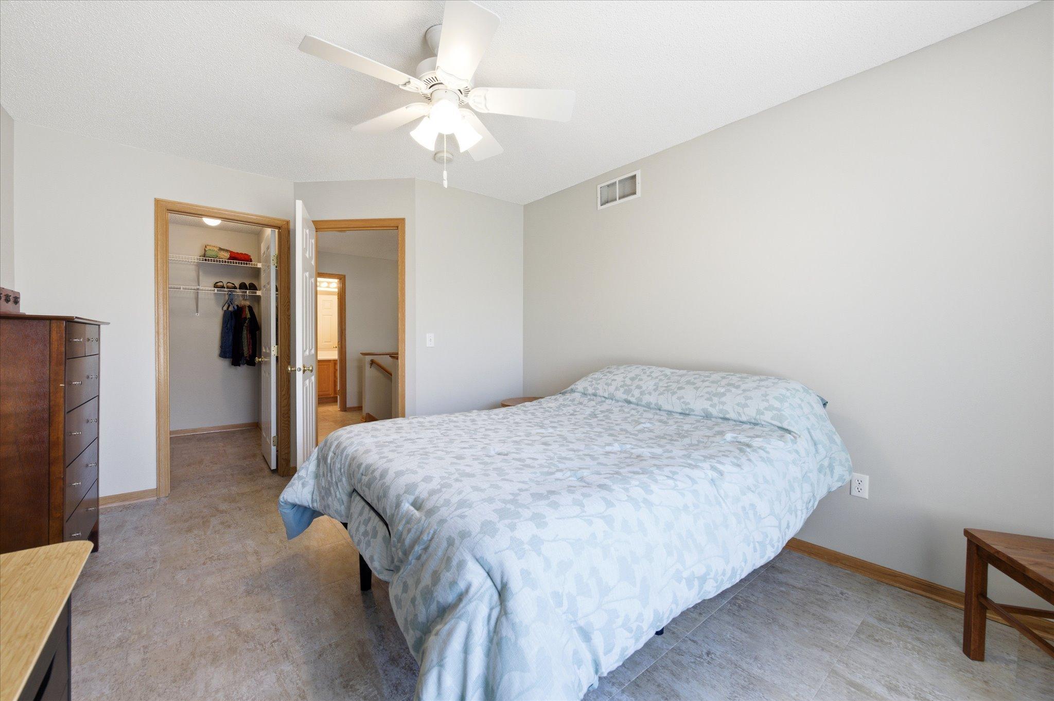 The spacious upper-level primary bedroom offers a relaxing retreat complete with a generous walk-in closet.