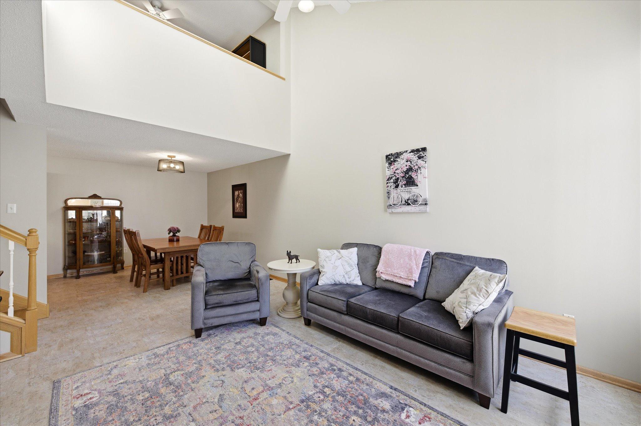 The spacious living room flows seamlessly into the dining area, creating an open and connected layout ideal for everyday living and entertaining.