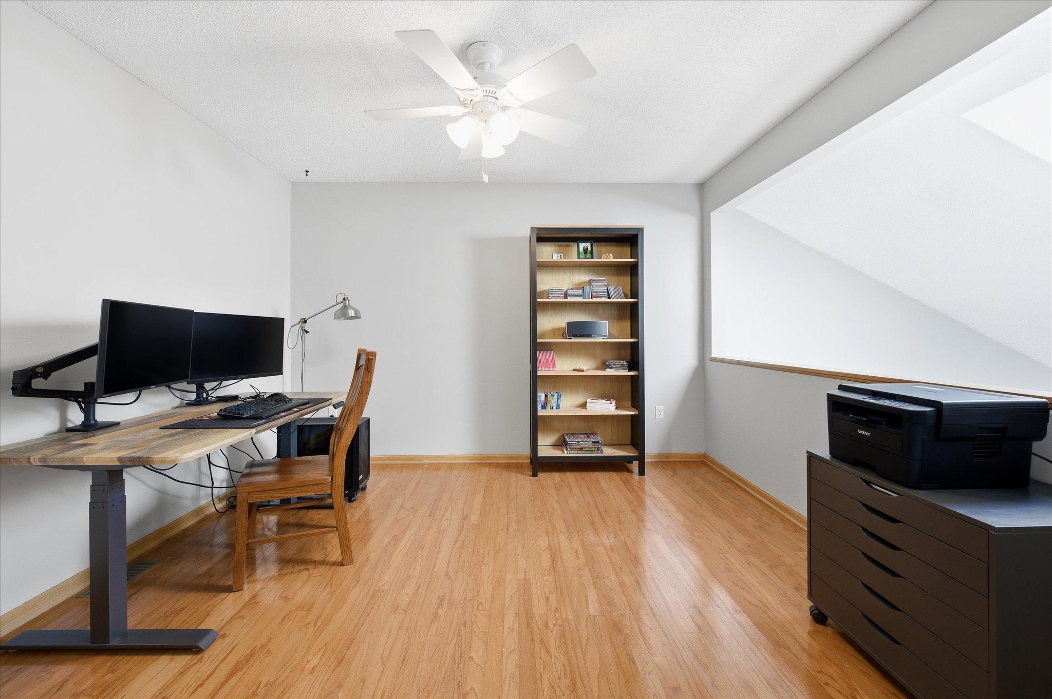 The versatile loft area is currently used as a home office but could easily become a reading nook, media space, workout area, or guest retreat.