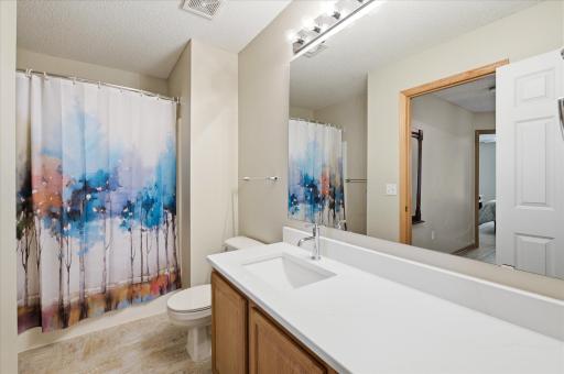 Bright and updated, the upper-level full bathroom features refreshed finishes including beautiful quartz countertops.