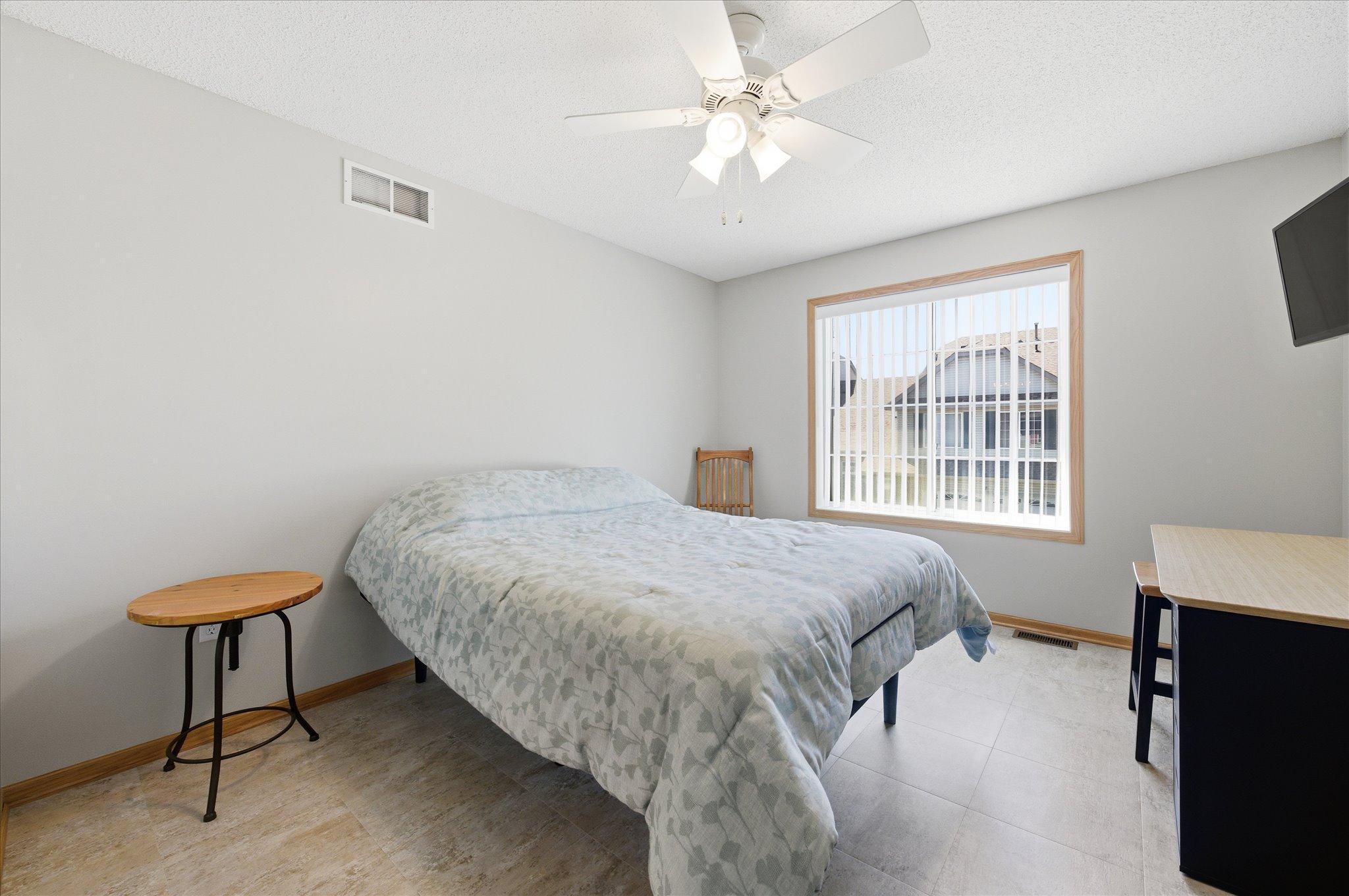 The spacious upper-level primary bedroom offers a relaxing retreat complete with a generous walk-in closet.