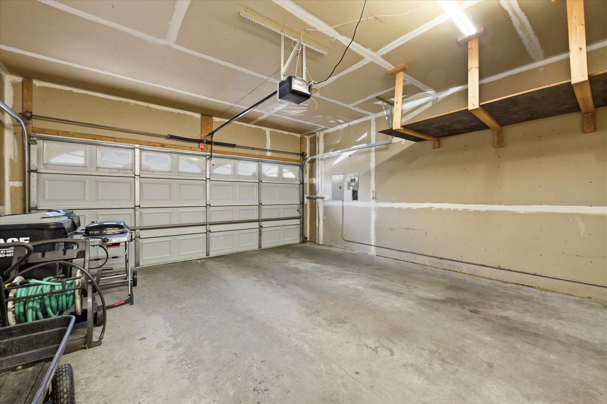 The attached garage offers generous space for vehicles, storage, tools, and outdoor gear.