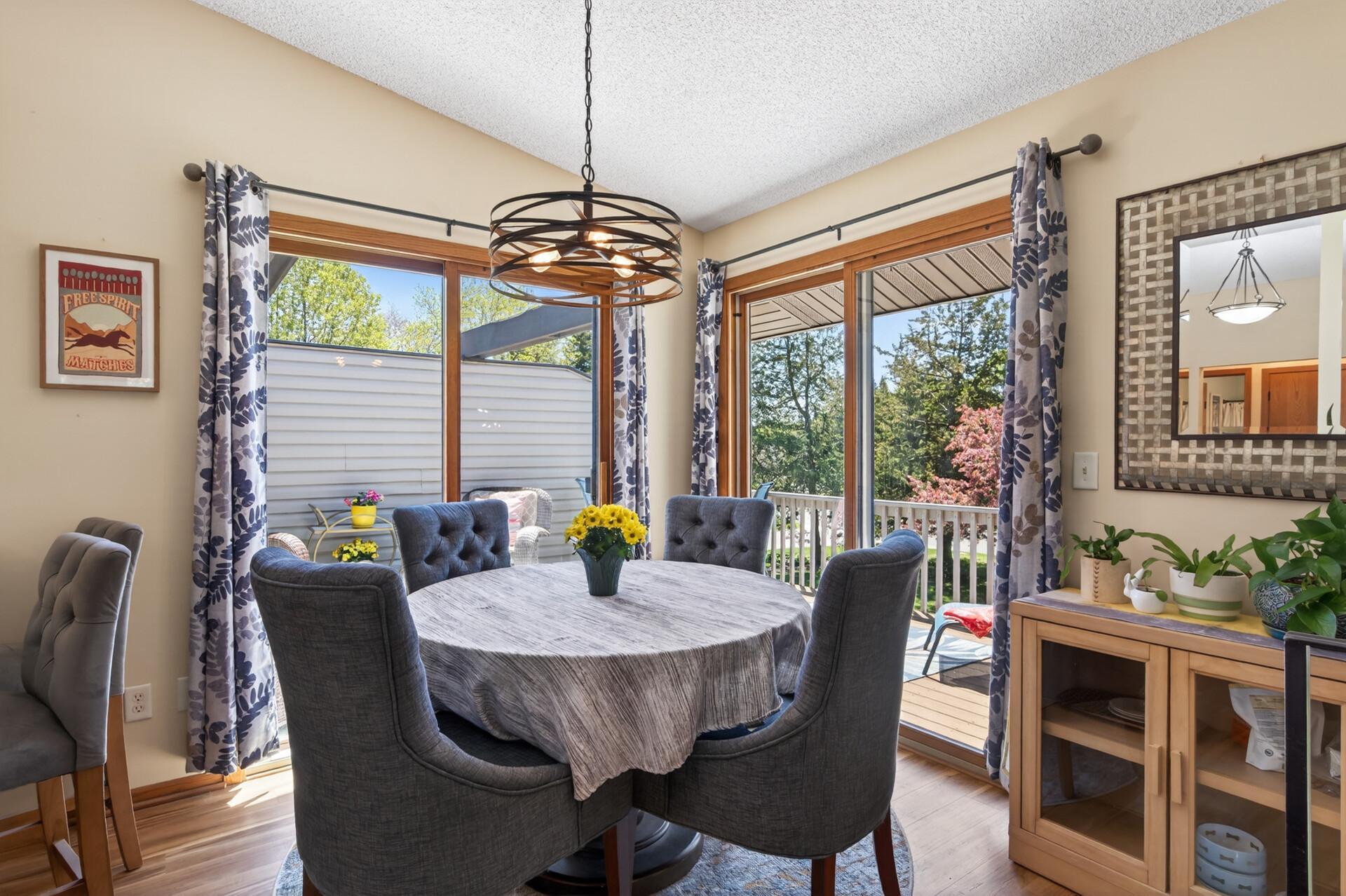 Sunny and bright dining area with two slider doors allowing for easy access to additional dining outdoors!