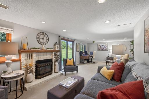 Walk-out with brick hearth gas fireplace, this room offers exceptional flexibility!