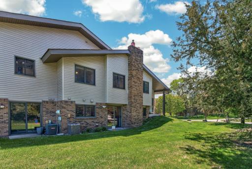 Expansive yard with perennial gardens surrounded by mature trees, rarely found in townhouse living!