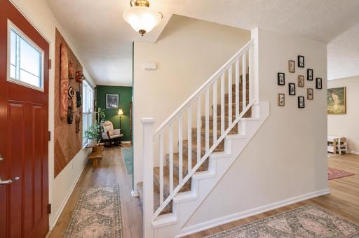 Central staircase divides the dining room from sitting room.