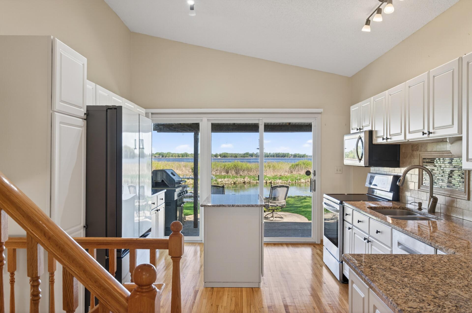 Beautifully updated kitchen with granite countertops, tiled backsplash, hardwood floors and newer stainless steel appliances.