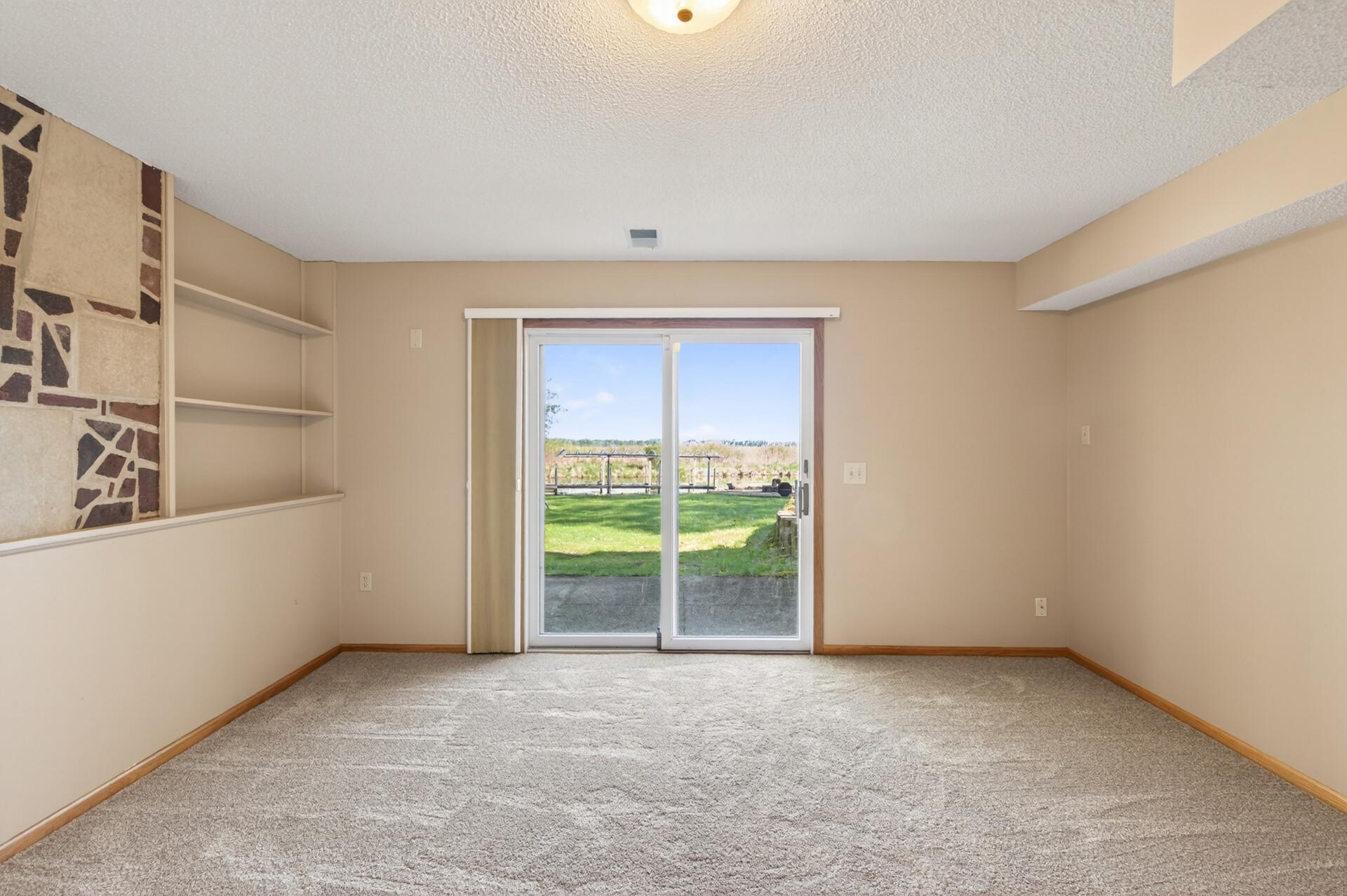 Lower level family room walks out to the backyard and offers beautiful views of Eagle Lake!