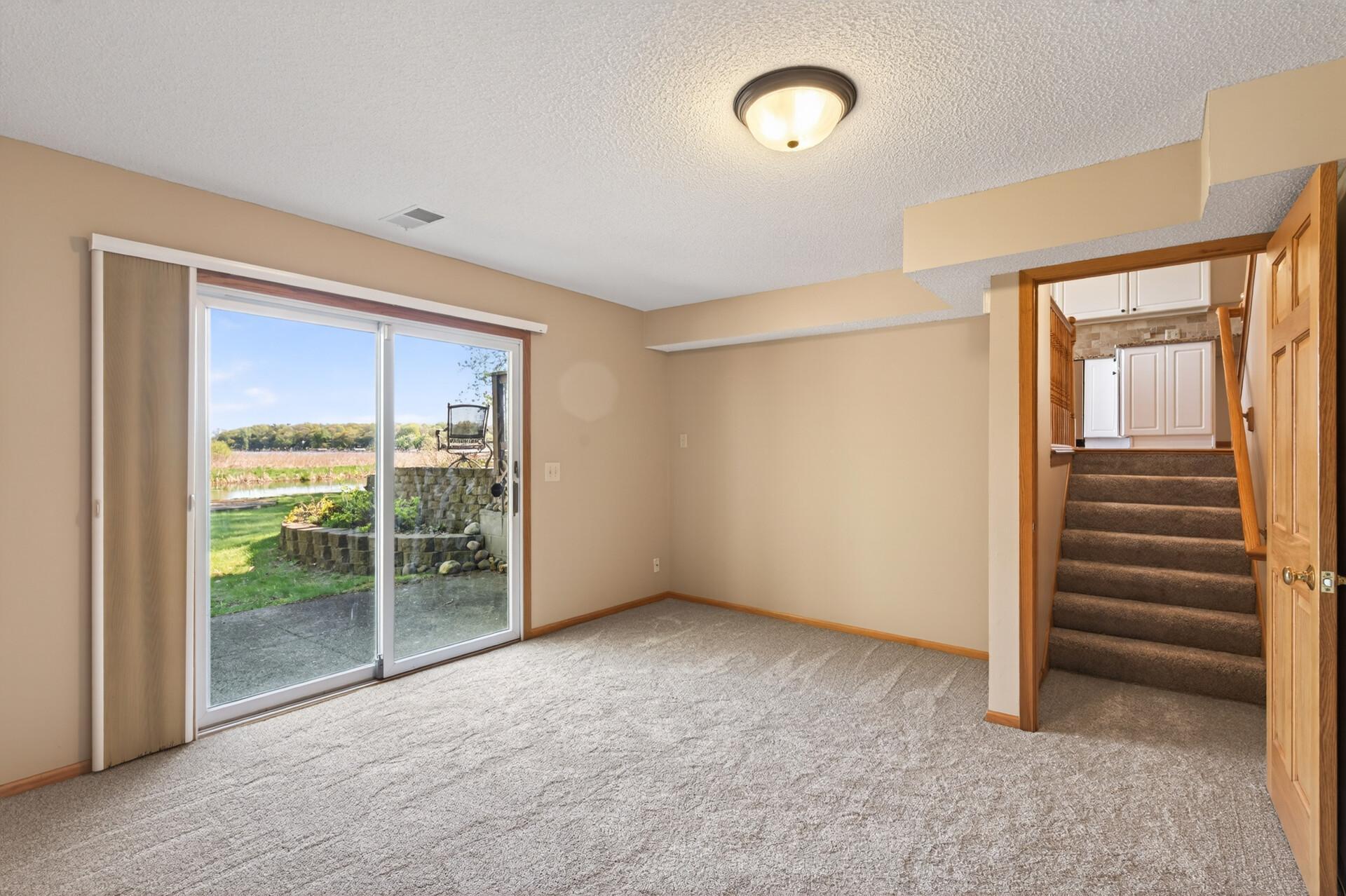 Lower level family room walks out to backyard and lake.