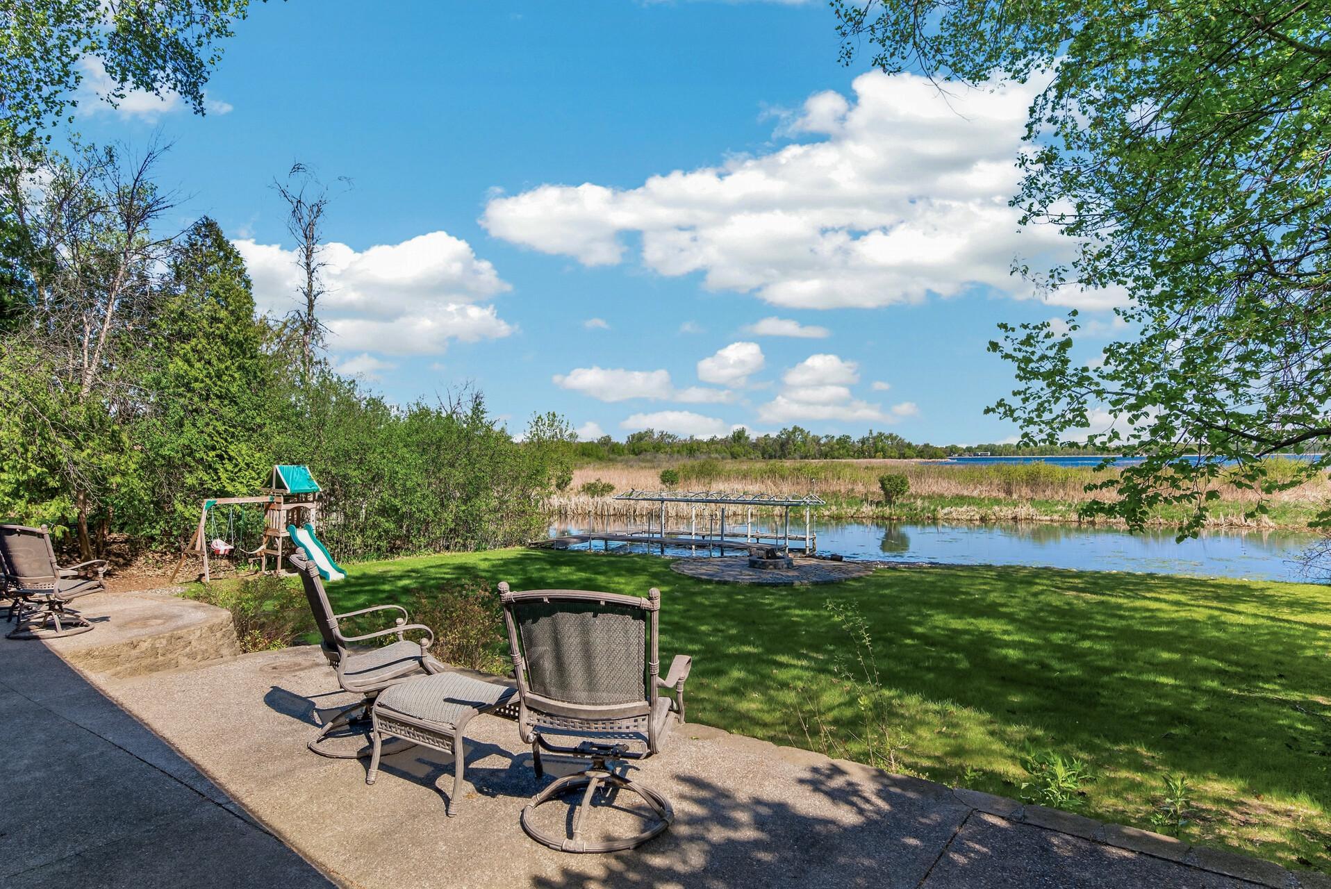 Huge patio in the back of the home for seating and taking in the private views and nature surrounding Eagle Lake!