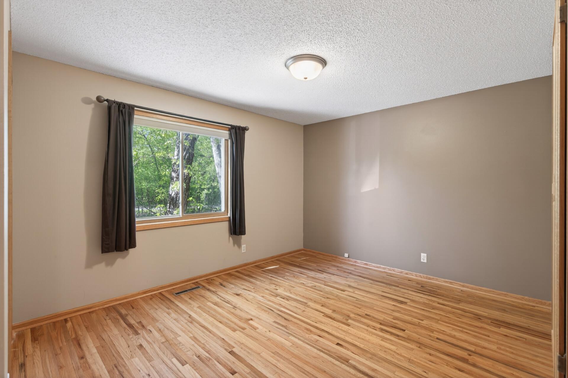 Bedroom 2 on the upper level with beautiful hardwood floors.