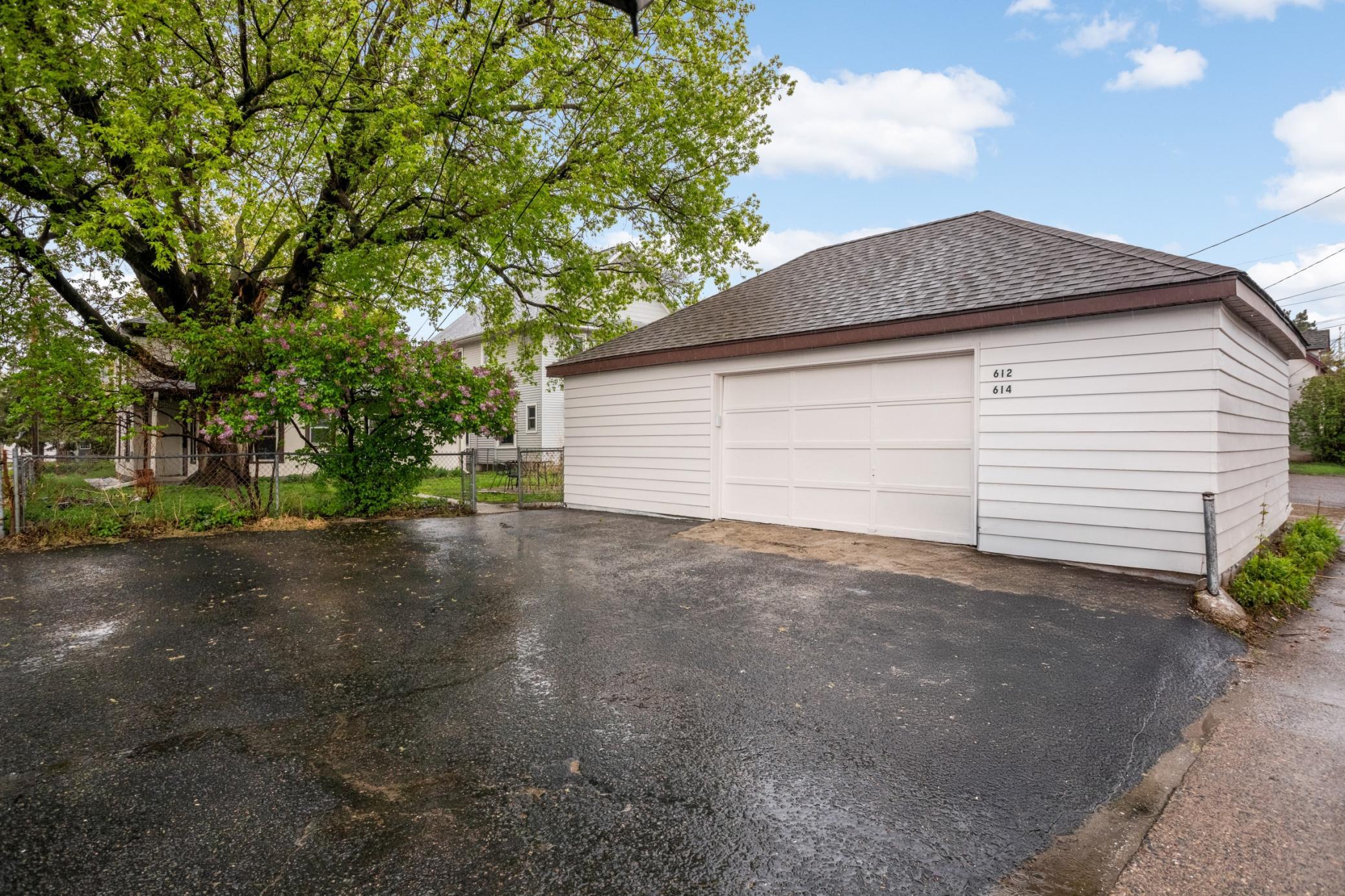 Garage building is 30x20. Wood siding professionally painted in April 2026. currently has off-street asphalt driveway 14x22 area for parking out of the way of the garage door, and one separate storage unit 11x10.5 in the garage accessible from ext.