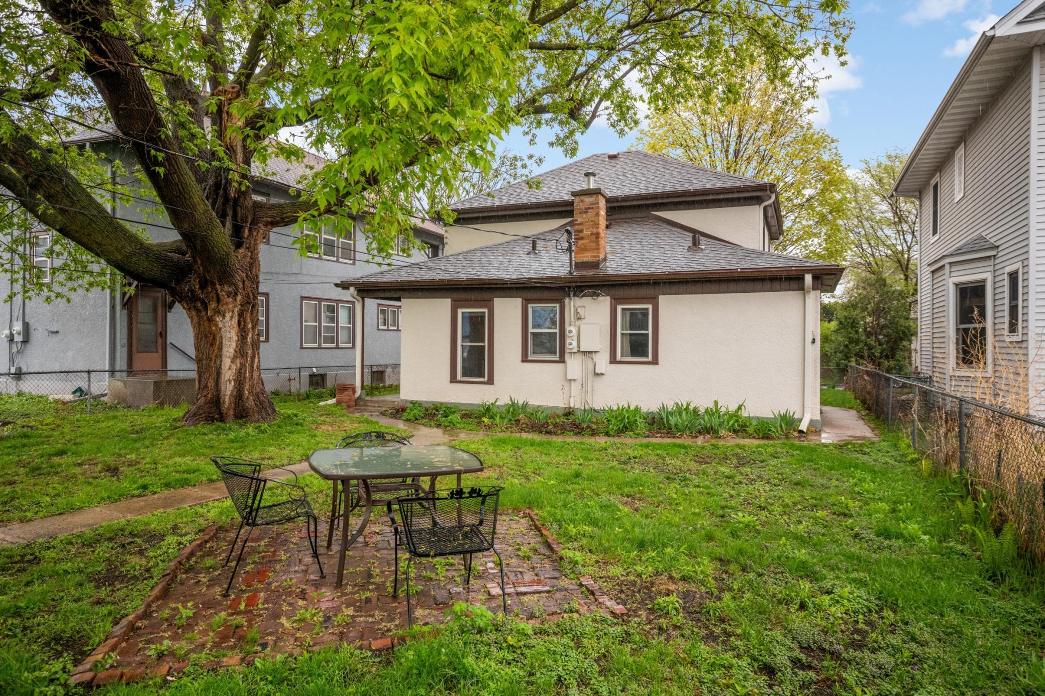 Fully fenced shared backyard space with brick patio