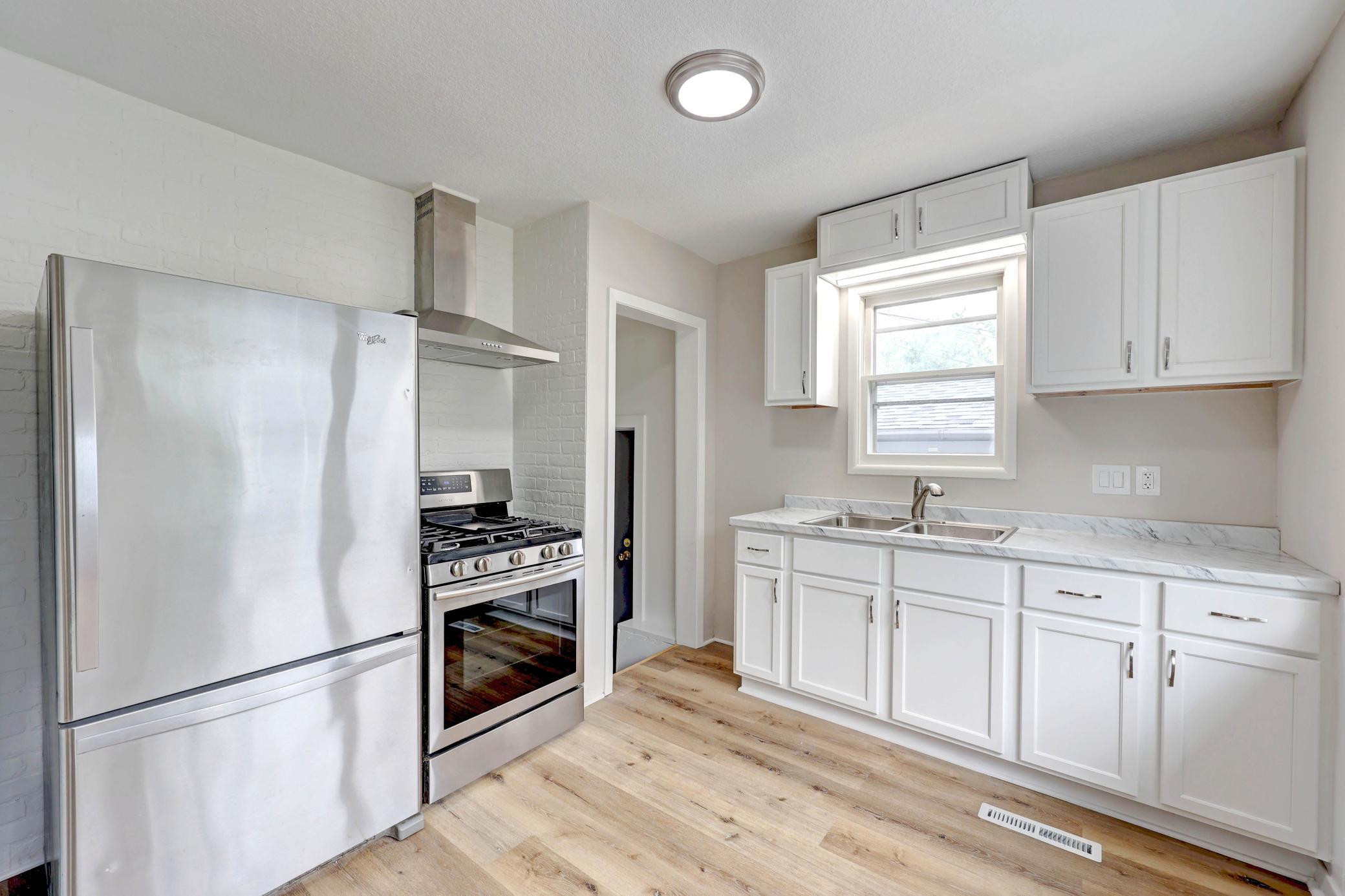 A New Kitchen and Fabulous Appliances at this Price!! Ample New Cabinets, Not Just Painted! The Stainless Steel Sink and Carefree Countertop make Cooking and Clean-up a Breeze. The Chic Oven Hood Reduces Odors.
