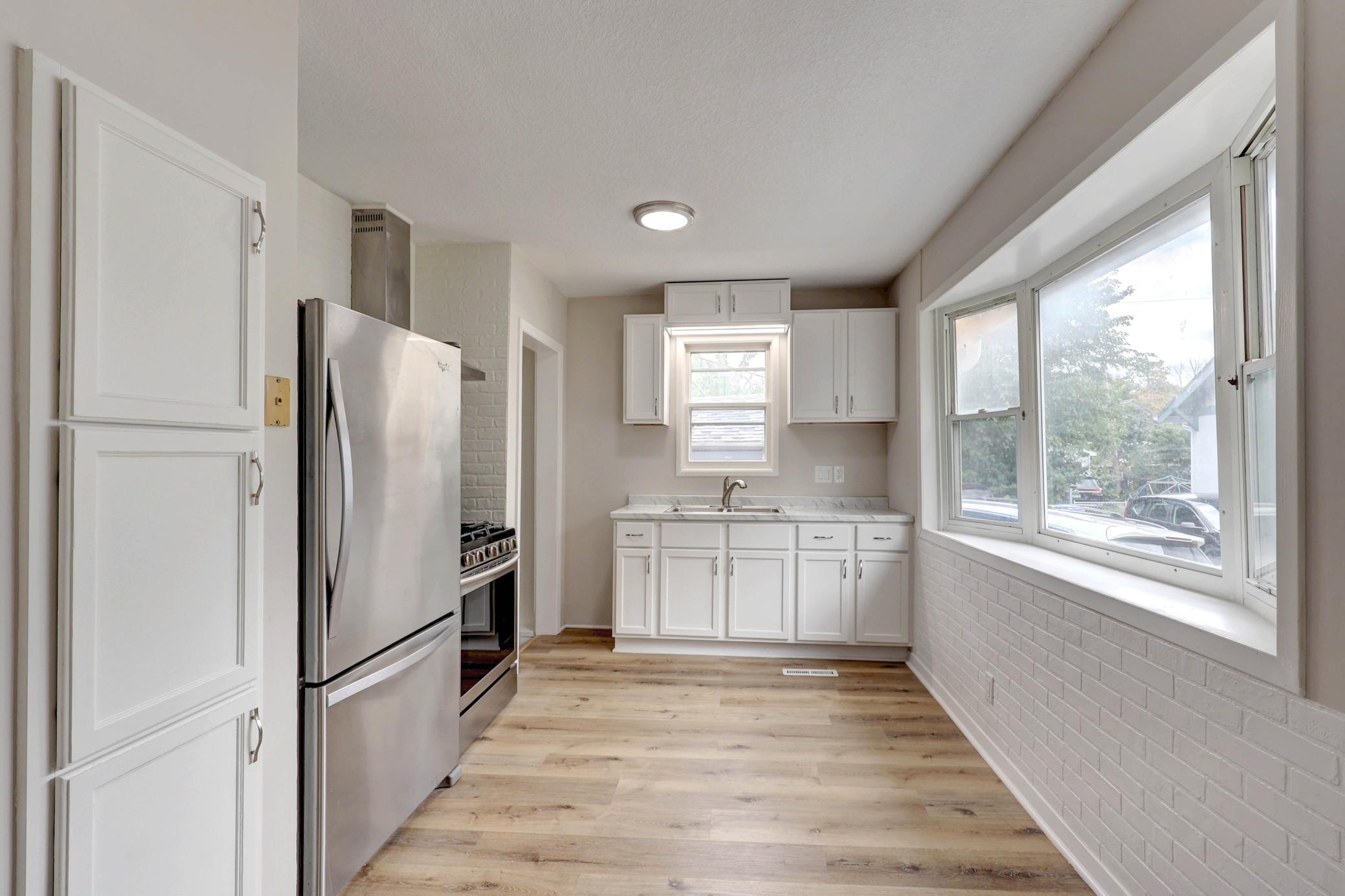 Wow! A Crisp, White Kitchen with Abundant Light from the Bay Windows Shining on Phenomenal Stainless Steel Appliances. You'll be the First to use the Samsung Five-Burner, Convection Oven Stove!