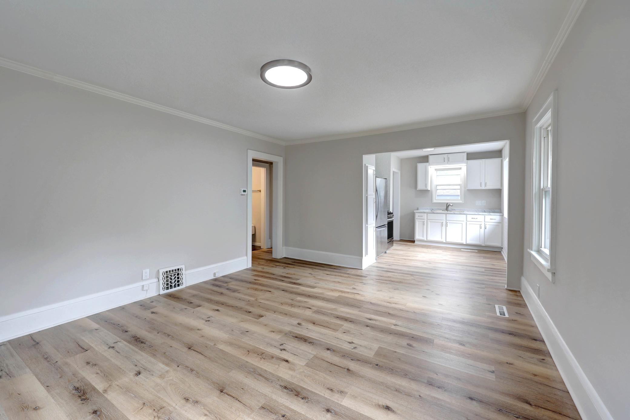 Enter the Spacious Great Room with Gleaming New Flooring Throughout, except the Bathroom. Everything is New, a Blank Pallet! Dove Gray Walls and On-Trend White Woodwork!