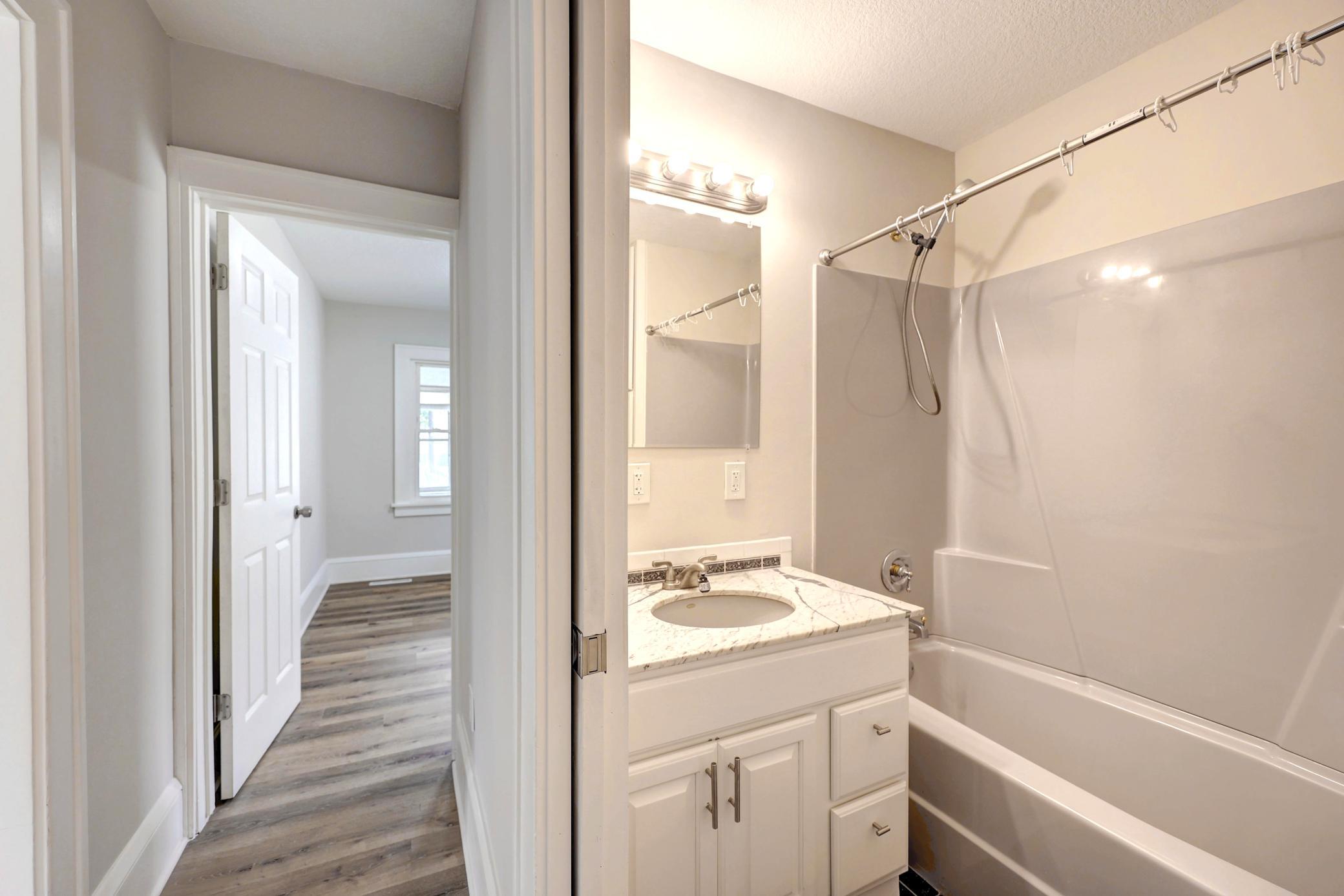 The Bathroom Maximizes Space with a Pocket Door. Ceramic Floor Tile makes Clean-up Easy!