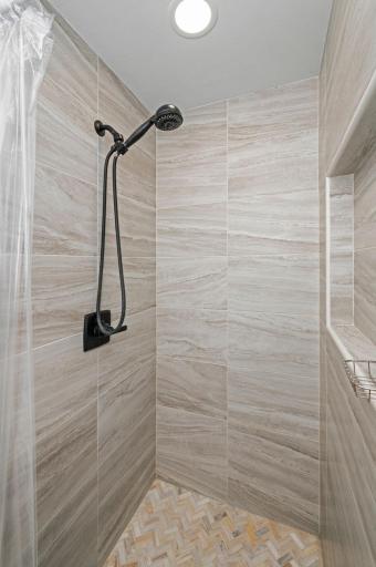 Lower Level has additional 3/4 bath with beautiful tile surround