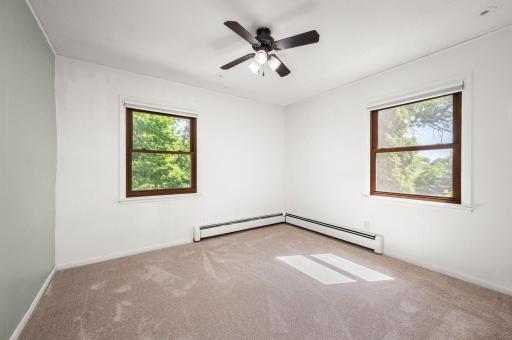 4th bedroom on main level with ceiling fan and new carpet!