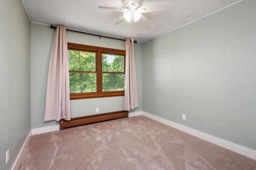 2nd bedroom on main level with ceiling fan and new carpet!