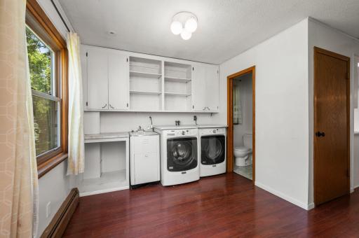 laundry room with a utility sink and a half bath