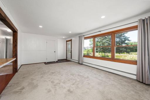 Step inside to a bright, open floor plan featuring fresh, brand-new flooring throughout