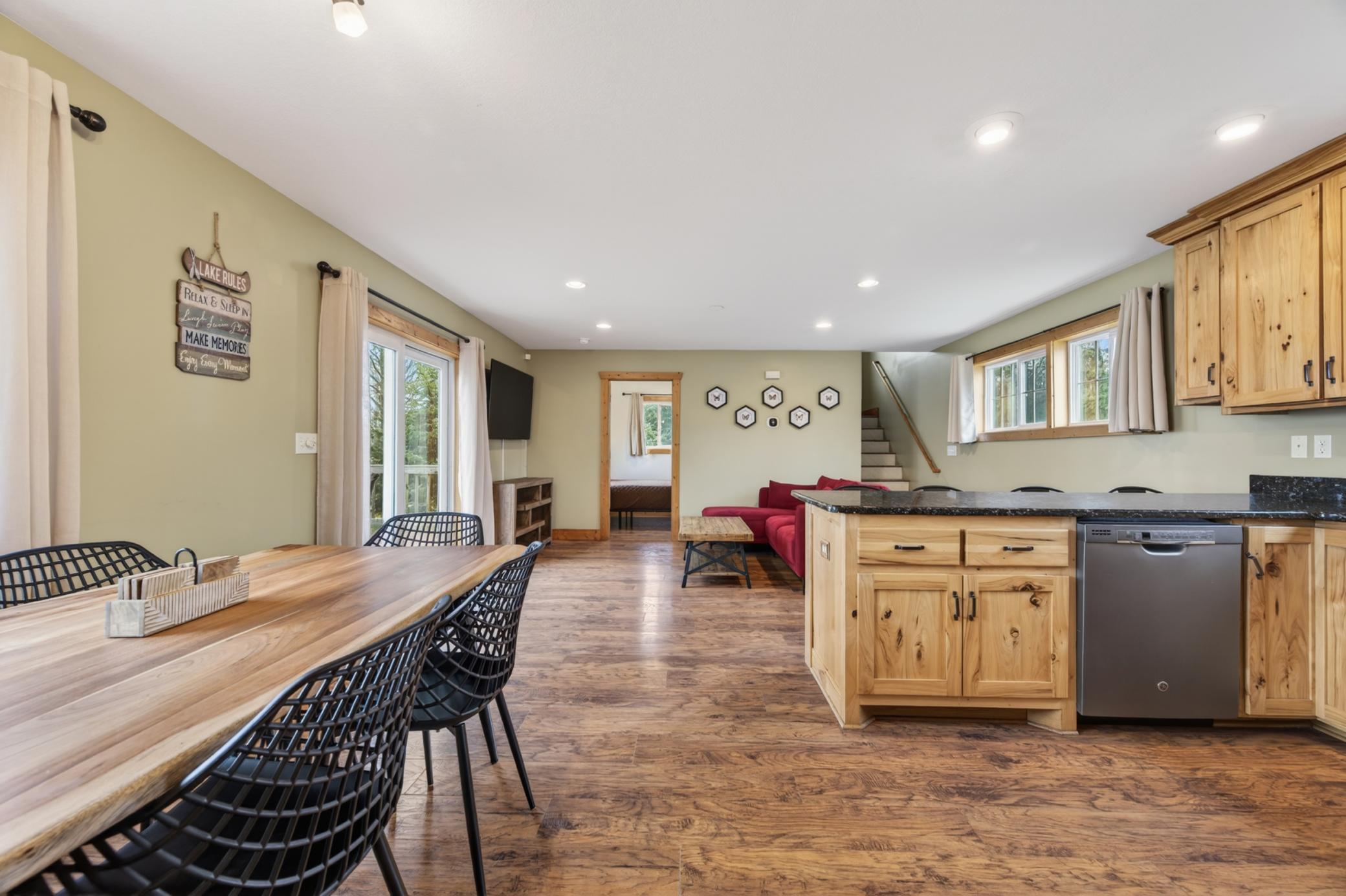 view from foyer into open concept kitchen, eat in kitchen, and living room. View into guest space.