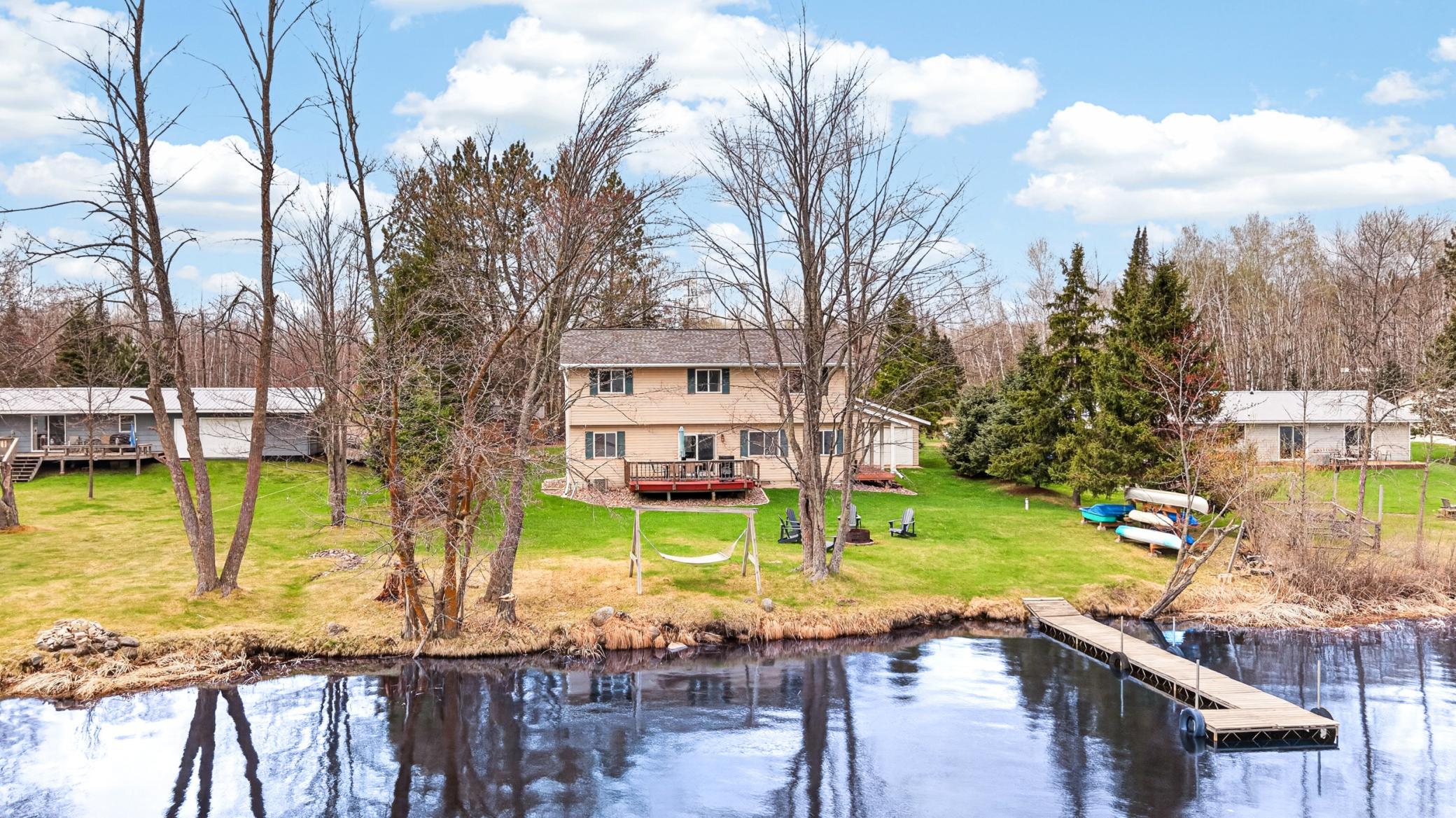 Back of home with dock & lake