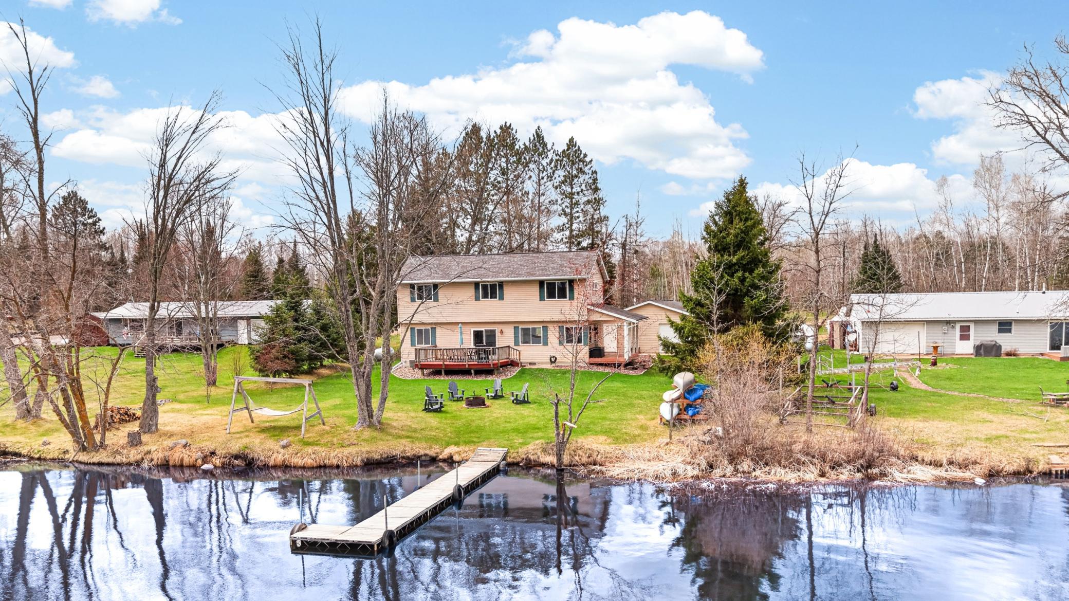 Back of home with dock & lake