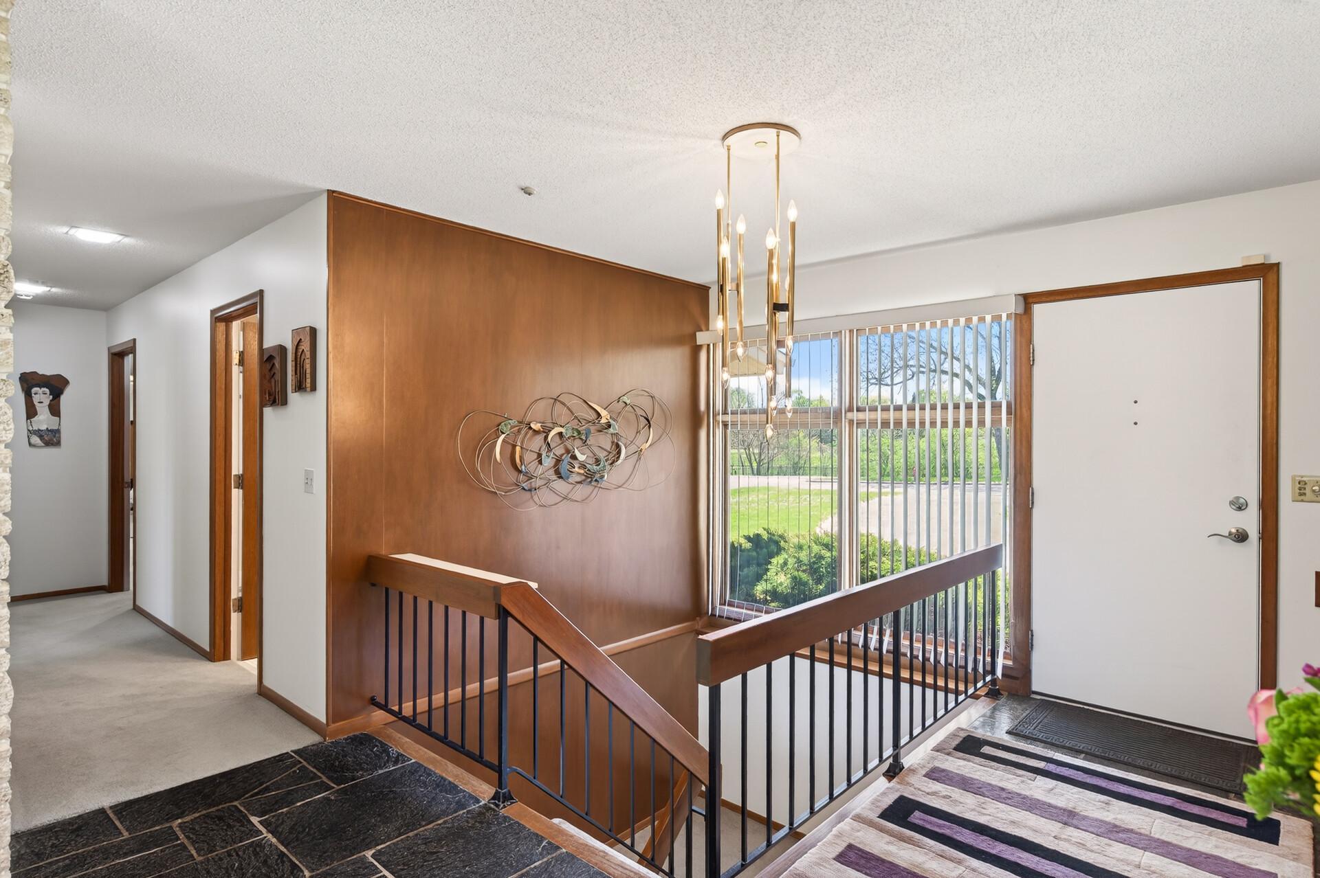 Split open stairway in the foyer provides natural light to the lower level