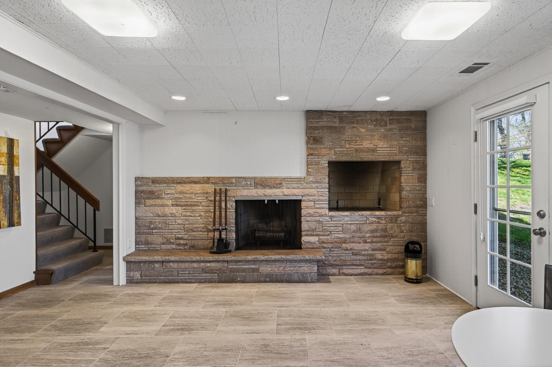 Stone fireplace wall in lower level