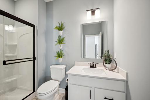 (Photo of a decorated model, actual homes finishes will vary) Main level bath.
